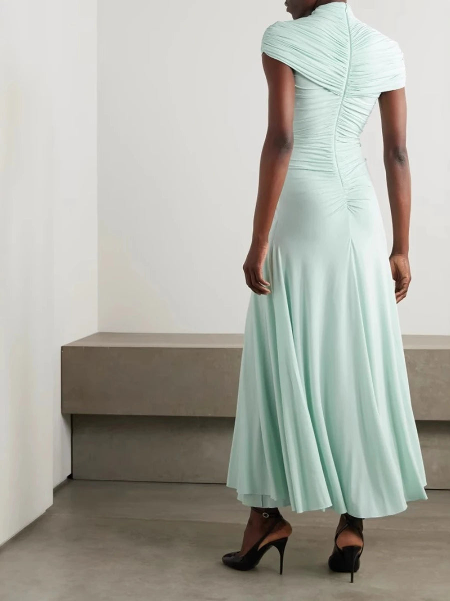Mint green dress worn by a model against a plain background