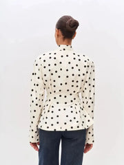 Back view of polka dot peplum blazer