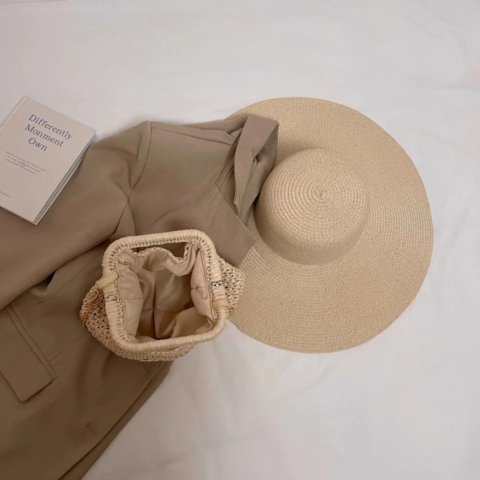 Beige hat, beige jacket, and woven bag on a white surface