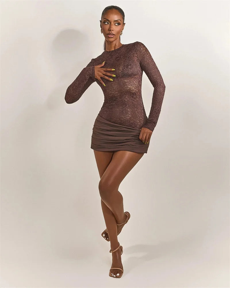 Woman wearing a brown long-sleeve dress against a plain background