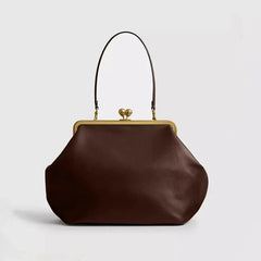 Brown handbag with a gold clasp on a light gray background