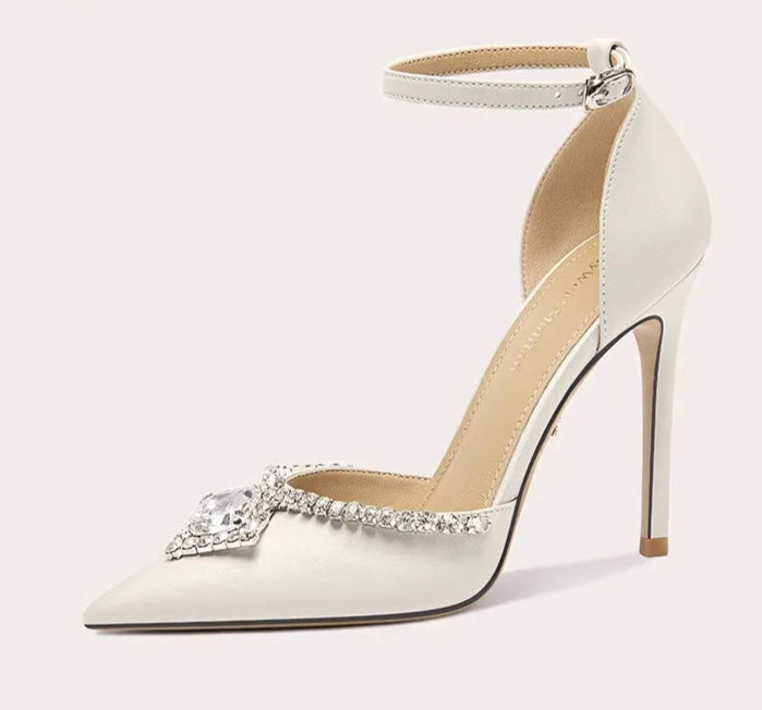 White high-heeled shoe with a decorative bow on a white background