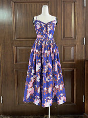 Floral dress on a mannequin against a wooden door background