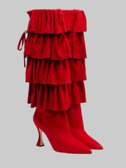Red ruffled high-heeled boots on a white background