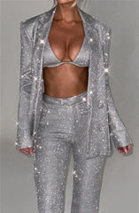 Person wearing a silver glittery suit on a gray background