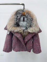 Purple coat with a fur hood on a hanger against a white background