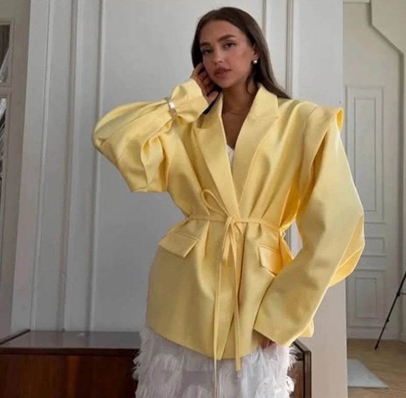 Woman wearing a yellow jacket in an indoor setting