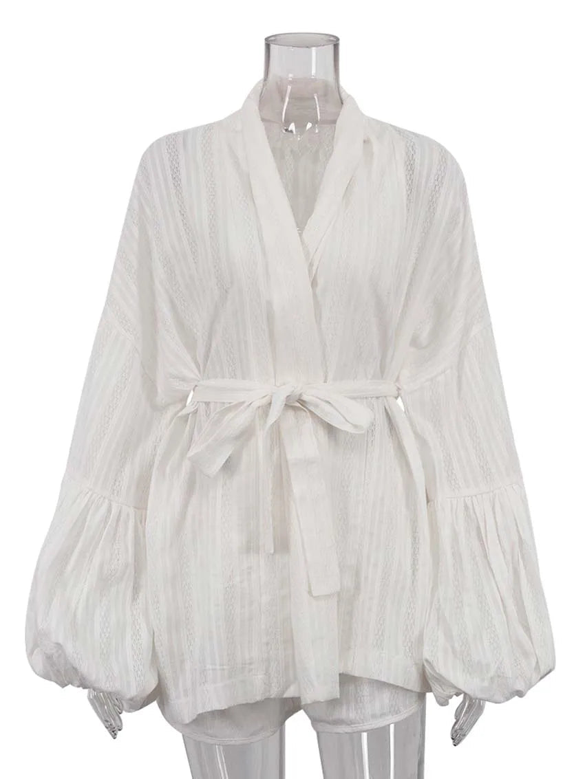 White blouse with long sleeves on a mannequin against a white background