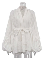 White blouse with long sleeves on a mannequin against a white background