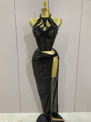 Black beaded evening gown on a mannequin against a plain background