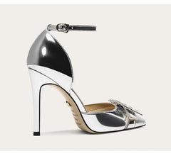 Silver high-heeled shoe with a strap on a light gray background