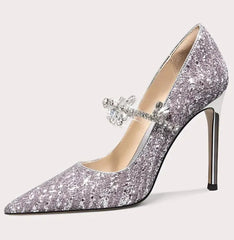 Silver glitter high-heeled shoe with a decorative bow on a white background