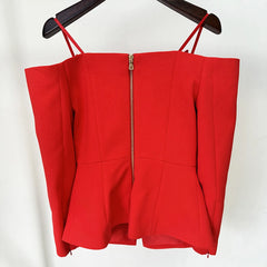 Red top with thin straps and a zipper on a white background