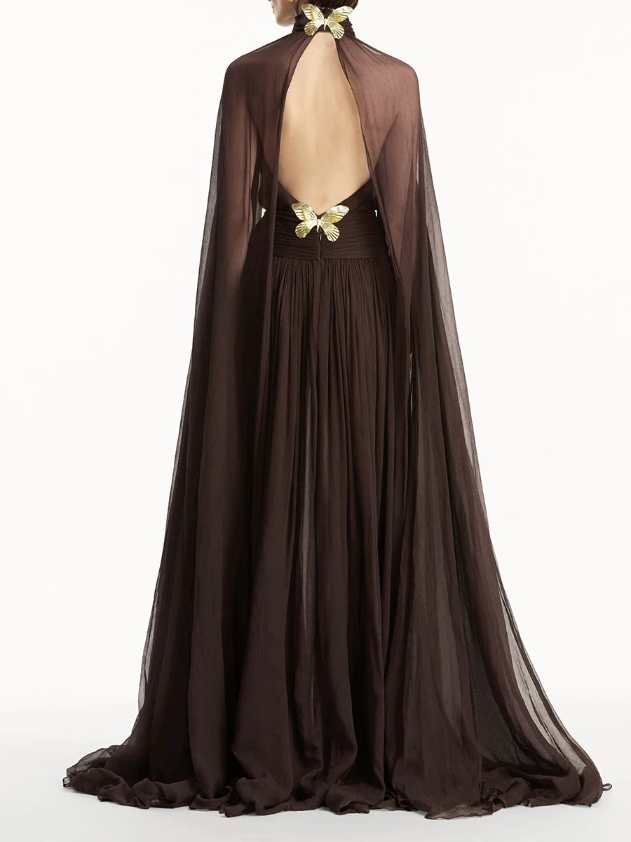 Brown evening gown with cape and floral back design on a white background