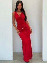 Woman wearing a red dress against a plain background