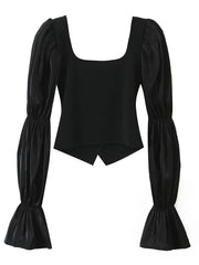 Black top with puffed sleeves on a white background