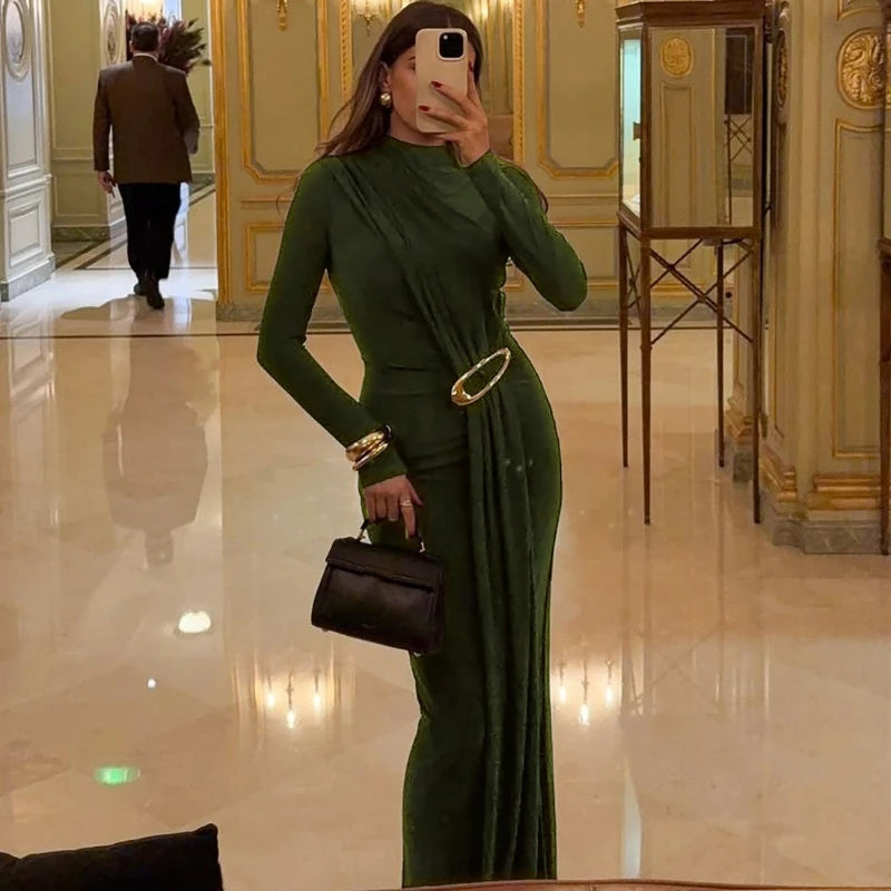 Green woven long sleeve gown displayed with refined drape.