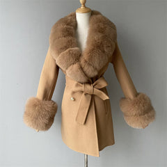 Beige coat with fur collar and cuffs on a mannequin against a gray background