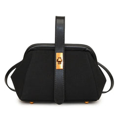 Black handbag with gold accents on a white background