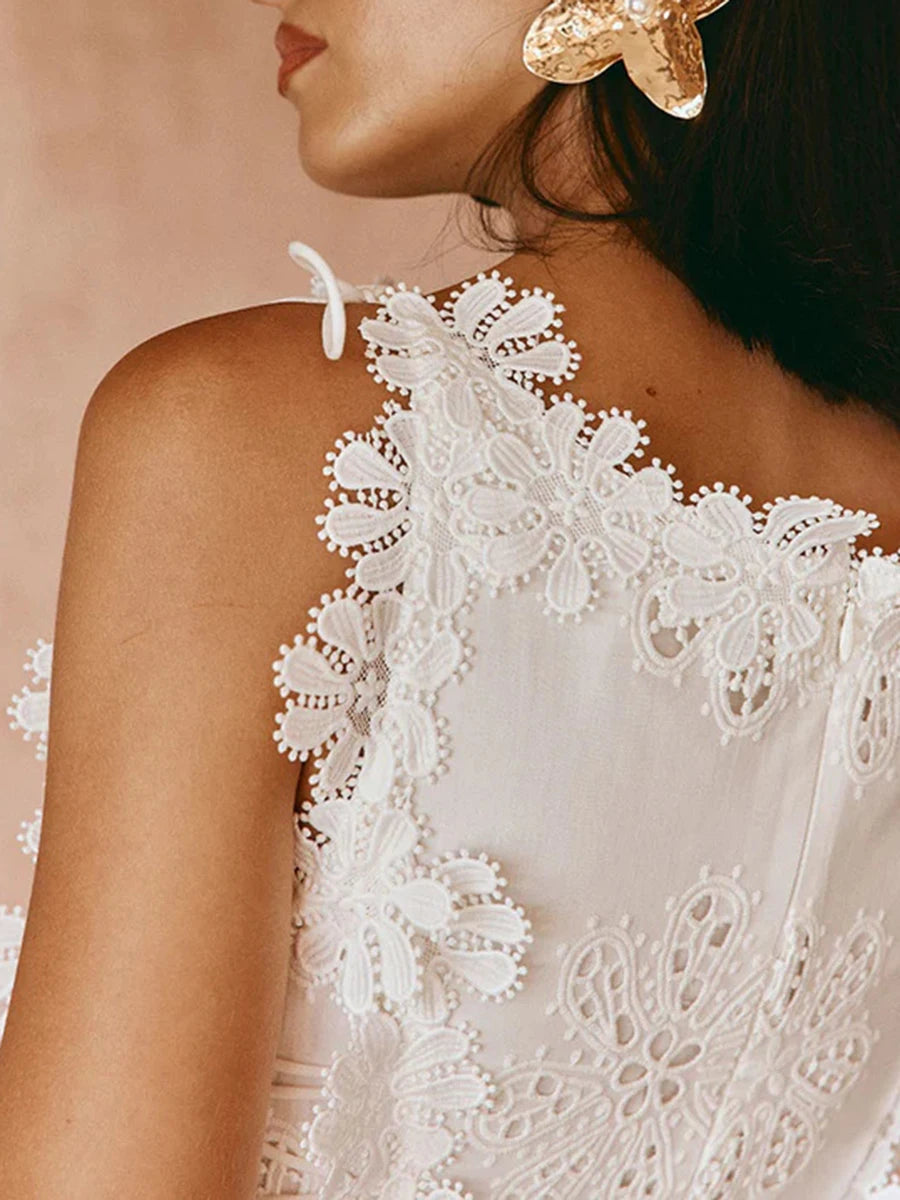 Close-up of a white lace dress with a blurred background