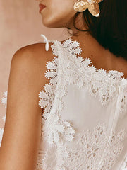 Close-up of a white lace dress with a blurred background