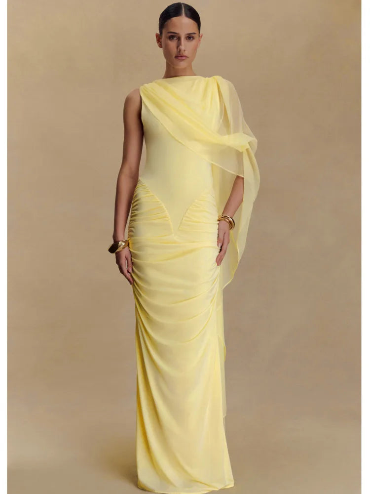 Woman wearing a yellow evening gown with a plain background