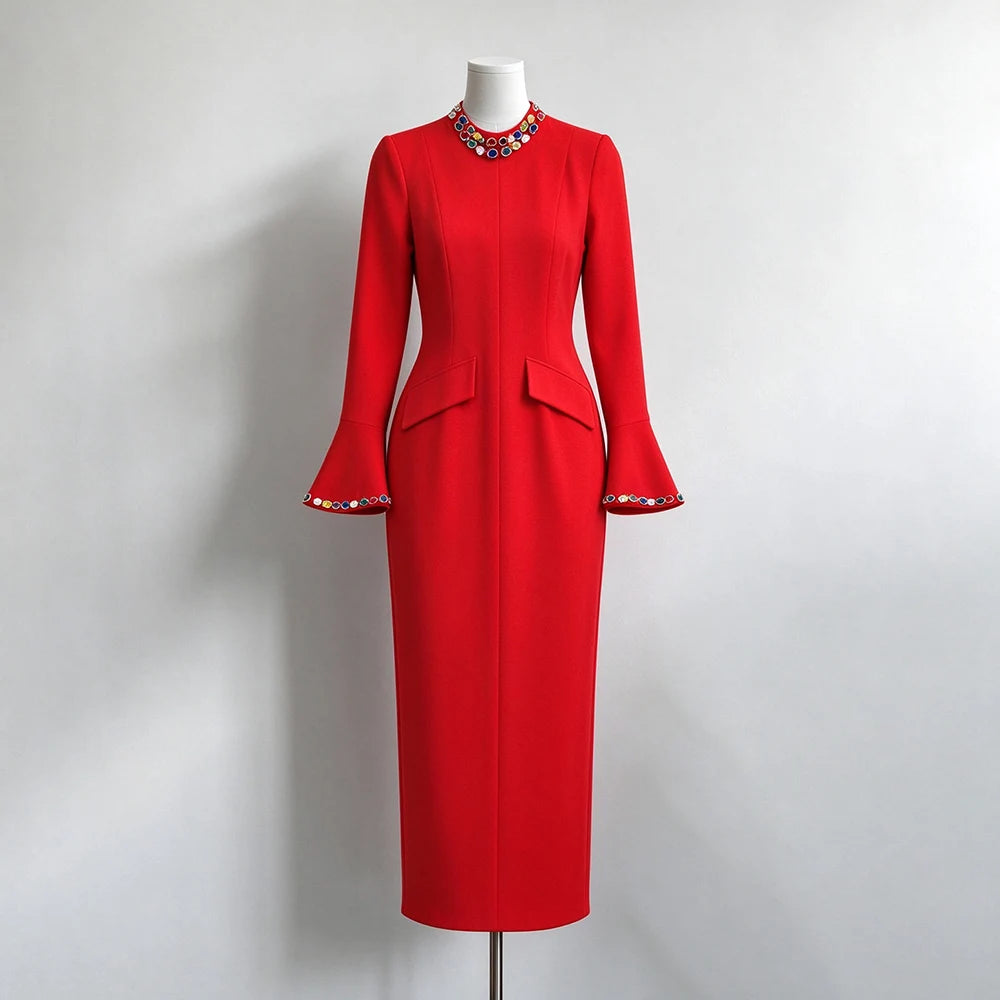Red formal evening dress with crystal embellished neckline and flared sleeves on mannequin