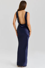 Navy blue evening gown with open back on a white background