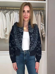 Woman wearing a patterned cardigan in a clothing store