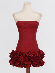 Red strapless dress with ruffled skirt on a mannequin against a white background
