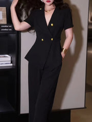 Person wearing a black suit with gold buttons in an indoor setting