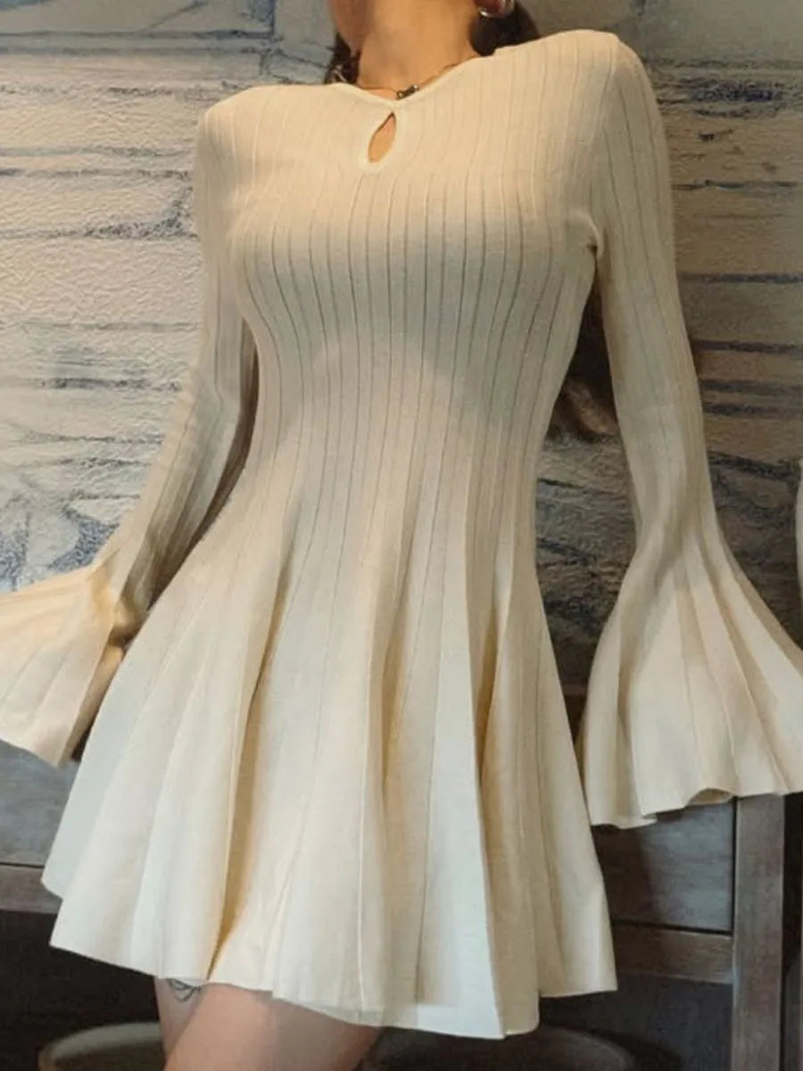 White ribbed dress with long sleeves on a marble background