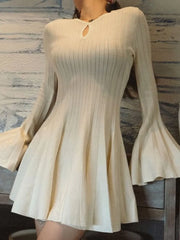 White ribbed dress with long sleeves on a marble background