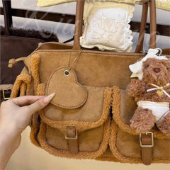 Caramel brown suede tote bag detail showing pocket and charm