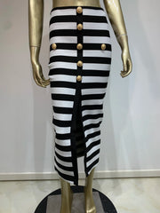 Black and white striped skirt with gold buttons on a mannequin against a plain background