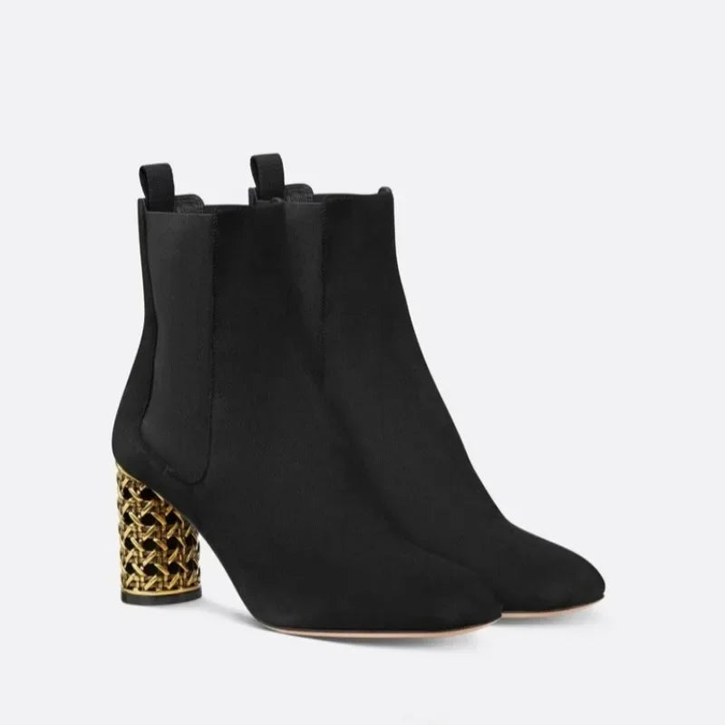 Pair of black suede ankle boots with gold hollow heels