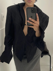 Relaxed long-sleeve plaid blouse styled with black trousers