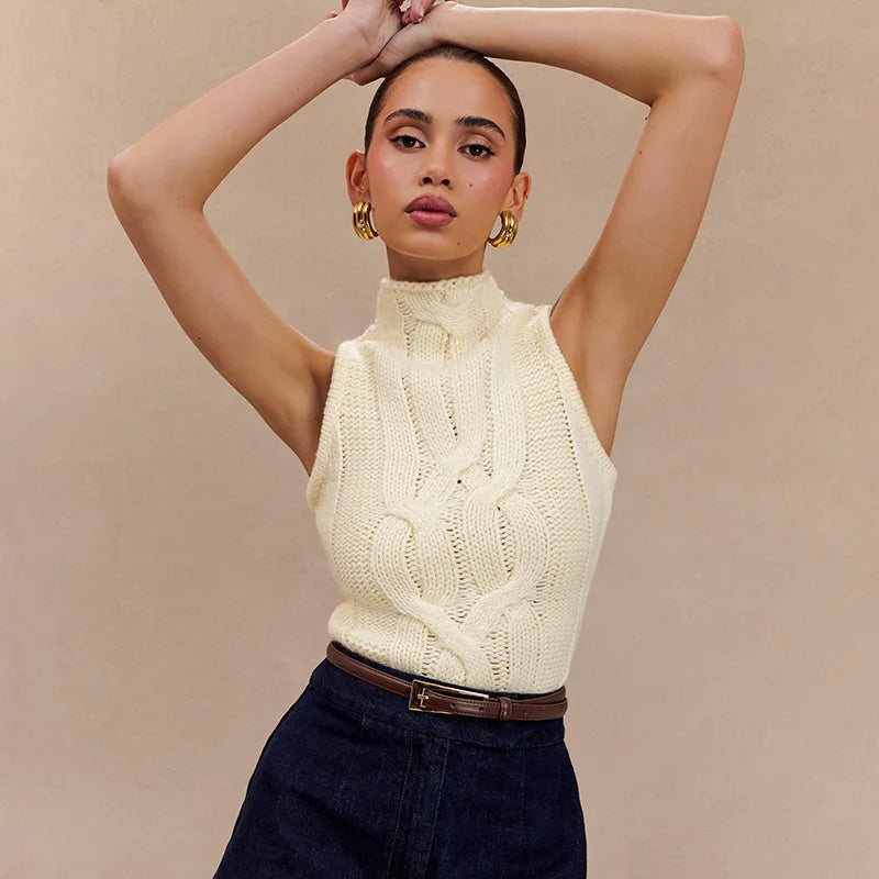 Woman wearing a cream knitted sleeveless top against a beige background