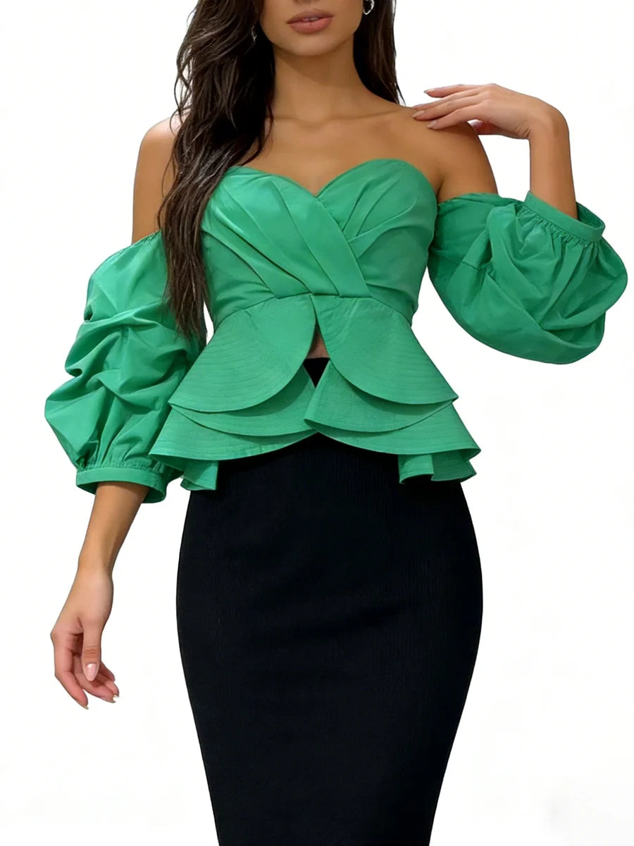 Green off-shoulder top with puff sleeves worn by a model on a white background