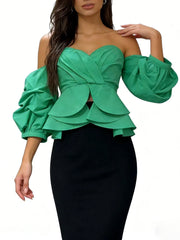 Green off-shoulder top with puff sleeves worn by a model on a white background