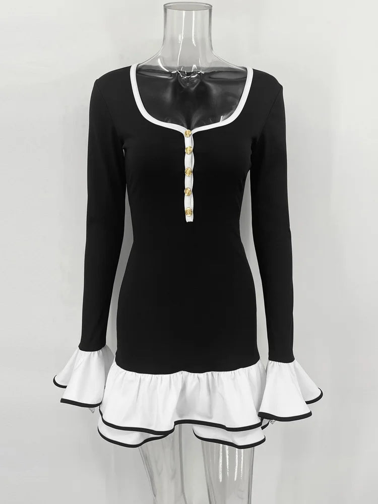 Black long-sleeve top with white trim on a mannequin against a white background