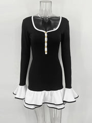 Black long-sleeve top with white trim on a mannequin against a white background