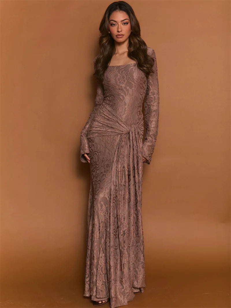 Woman wearing a long, patterned dress against a brown background