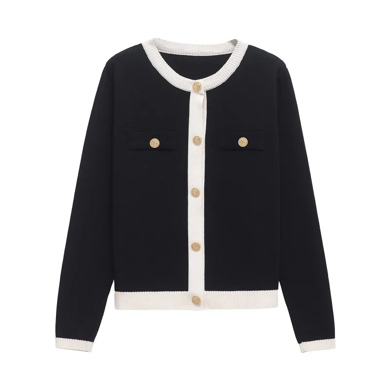 Black cardigan with white trim and gold buttons on a white background