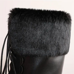 Black fur-trimmed boot on a light gray background