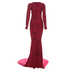 Red evening gown with long sleeves and a bow detail