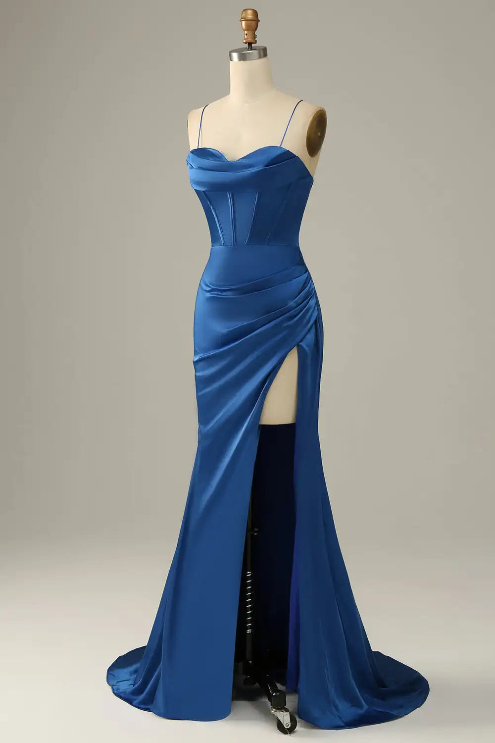 Blue evening gown on a mannequin against a plain background