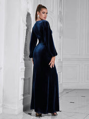 Woman wearing a long blue velvet dress in an elegant interior setting