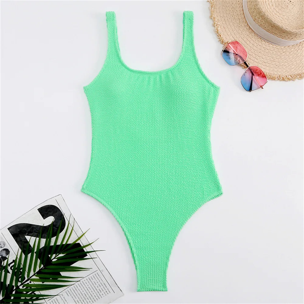 Green ribbed high-cut one-piece swimwear laid flat