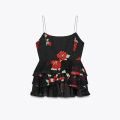 Black top with red floral patterns on a light gray background